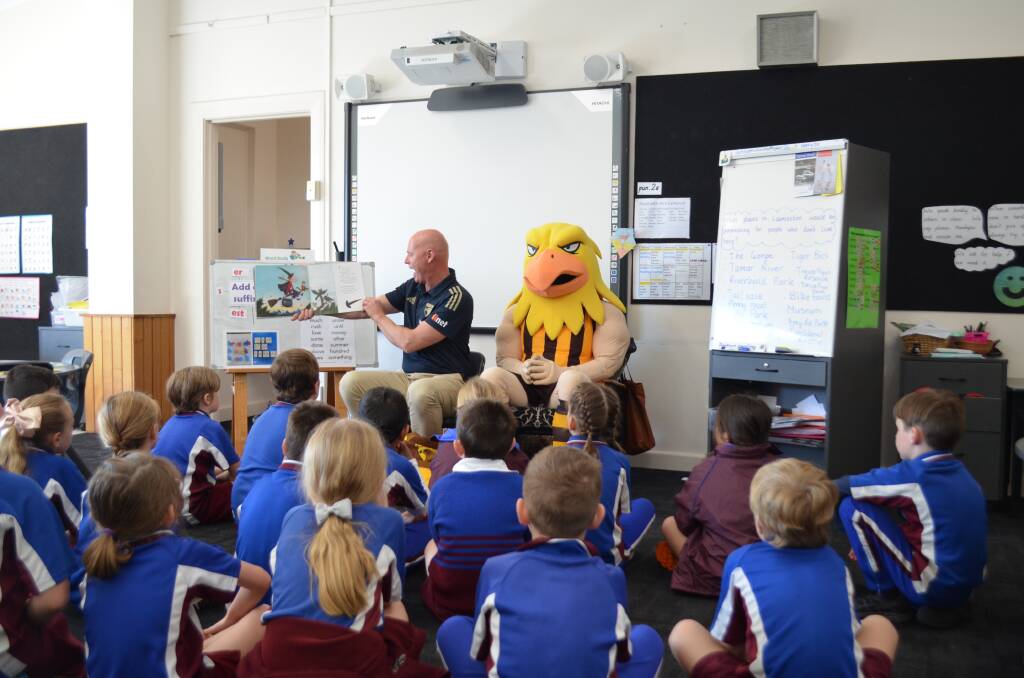 READERS: Hawthorn state manager David Cox and Hawka read with the Punchbowl Primary School year 2 class. Picture: Adam Daunt