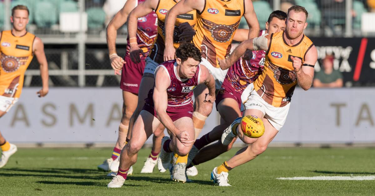 MIDFIELDERS: Lachie Neale and Tom Mitchell found plenty of the ball for their respective sides. Picture: Phillip Biggs