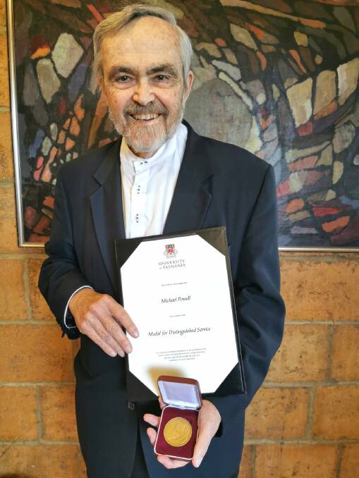RECOGNISED: Michael Powell with his distinguished service medal from the University of Tasmania. Picture: Supplied