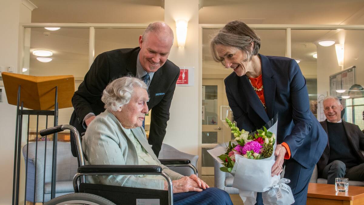 102 year old Eileen Holcroft presents flowers to Professor the Honourable Kate Warner, Governor of Tasmania with Home manager Peter Francis Pictures: Paul Scambler