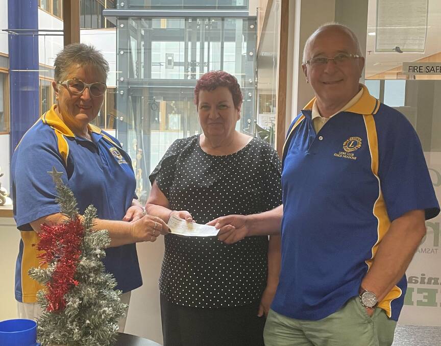 Kings Meadows Lions Club vice president Judi Gorham and president Dennis Mann present a cheque to The Examiner's Kathy Nicholas. Picture: Sarah Davison 