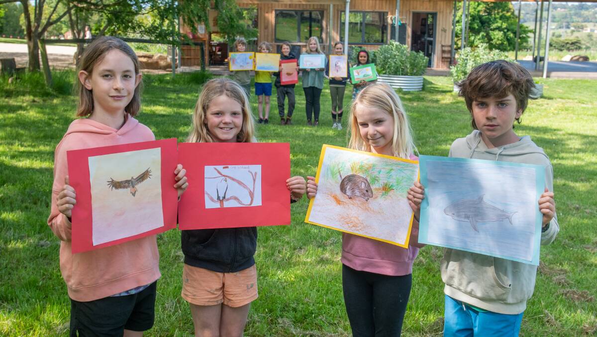 ARTISTIC EXPRESSION: Atticus McNaught 10, Gracie Bidwell 9, Nina Bauer 10, and Eden Willmott 10 and classmates show off their drawings of endangered animals. Picture: Paul Scambler