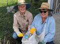 Sadie Roberts and Beylara Ra help clean up Riverbend Park. Picture Brett Jarvis