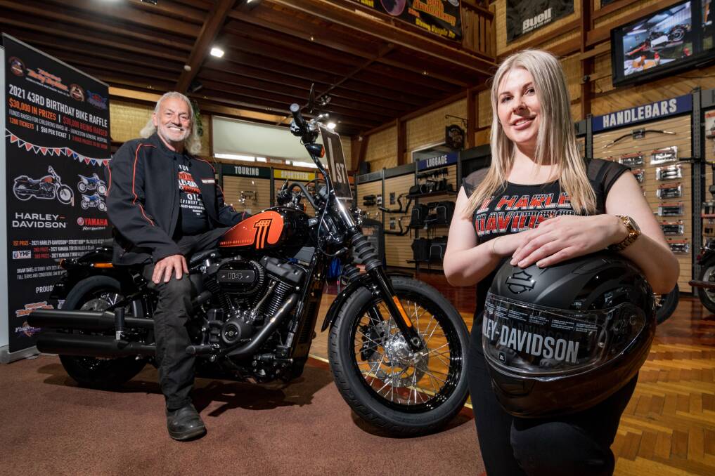 LETS RIDE: Simon Hrycyszyn and Lindelle Curran-Hrycyszyn with Saturday's 1st prize a Harley-Davidson FXBBS Street Bob 114. Picture: Phillip Biggs