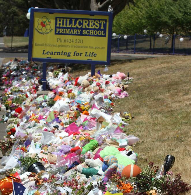 Flowing tribute: The floral tribute continues to grow outside Hillcrest Primary School. Picture: Rodney Woods.