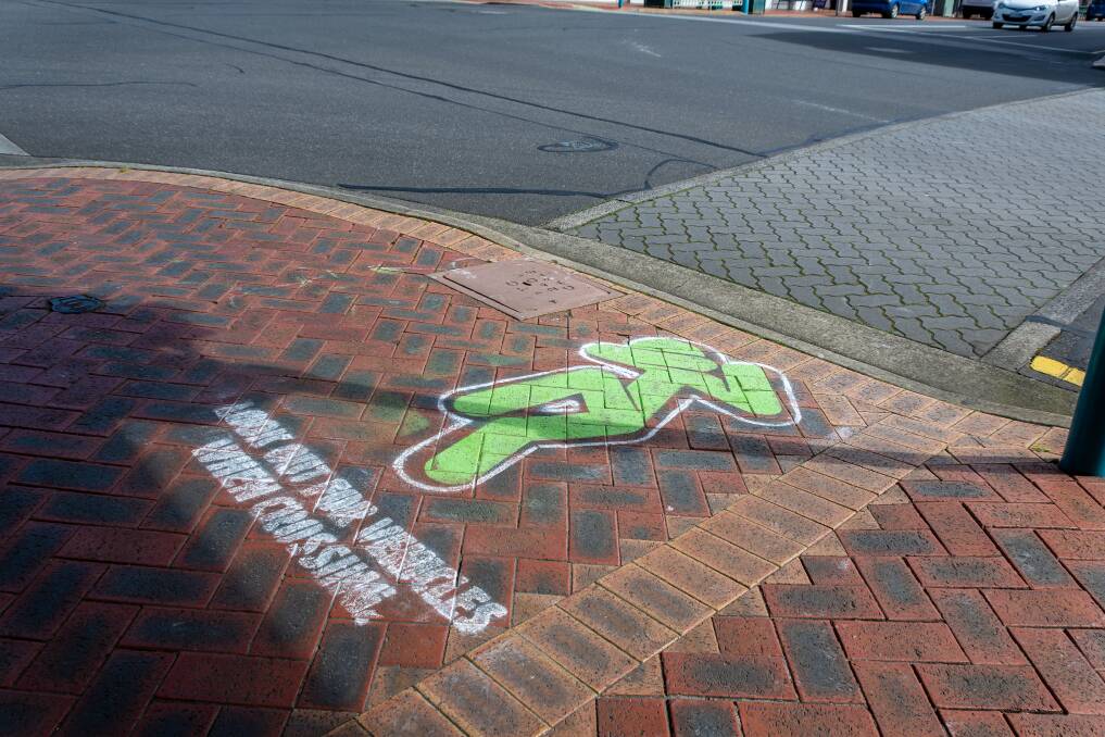 Watch out: The 'green walk signal' flinching has been stenciled onto footpaths across the state to draw attention to the issue of pedestrian safety. Picture: Simon Sturzaker.