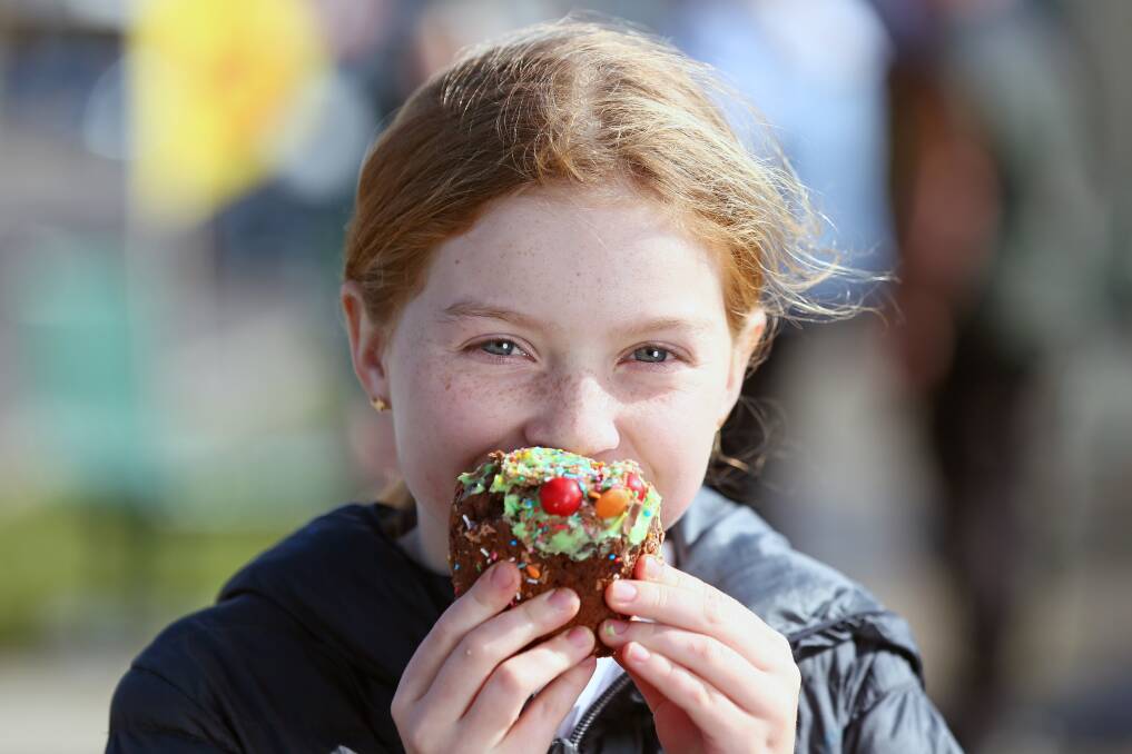 Taking a bite: Emilie Taylor, 9, of Latrobe, enjoys the food on offer at Latrobe's Chocolate Winterfest. The event returned for the first time since 2019. Pictures: Rodney Braithwaite.