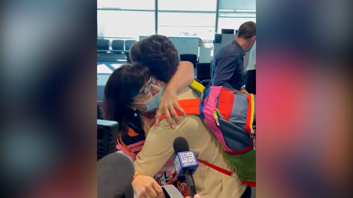 A mother and son (pictured) were reunited at Brisbane Airport on Monday after Queensland reopened its borders. 