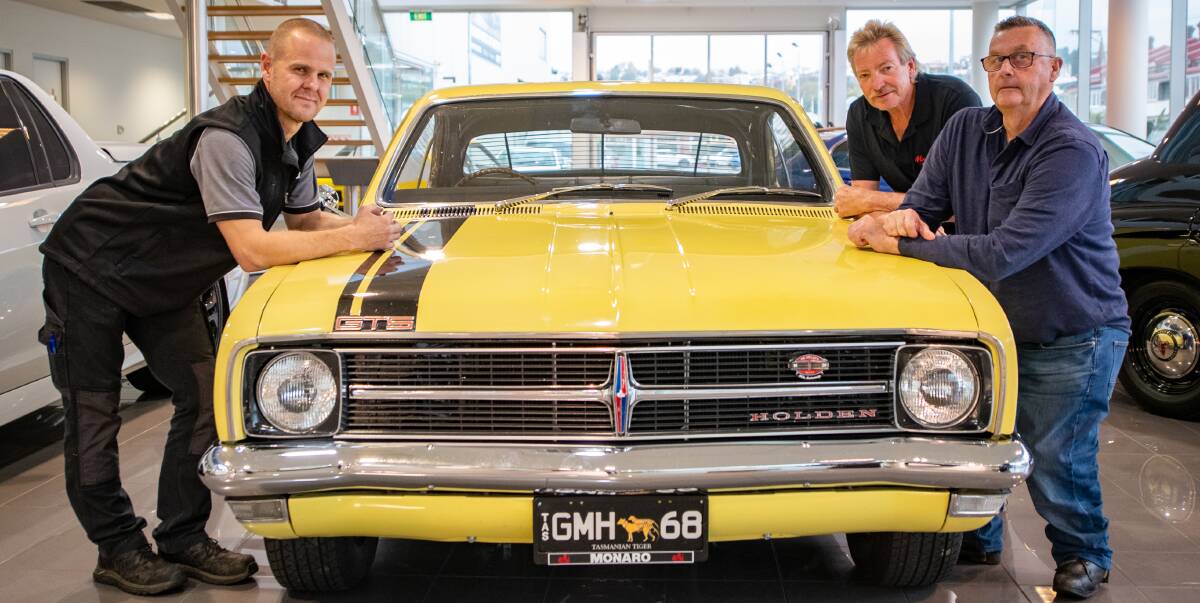 VROOM: Motors' David Monks, President of Monaro and GM Club Tasmania Ken Tatto and treasurer Greg Denholm with Ken's 1968 Monaro. Picture: Paul Scambler 