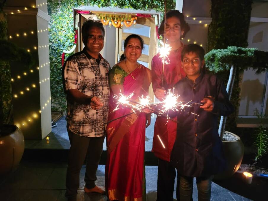 LIGHT AND LOVE: The Eri family celebrating Diwali with sparklers at their home. Picture: Supplied 