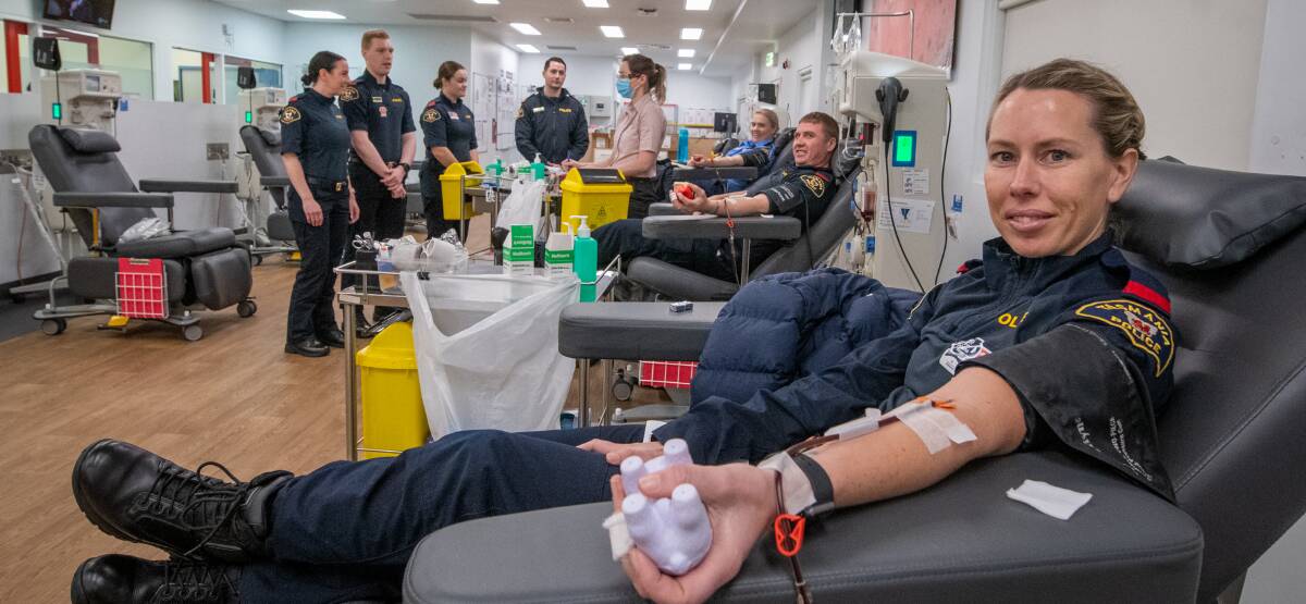 SAVING LIVES: Tasmania Police Launceston recruit Ebony Manion donates blood, with fellow officers for the Emergency Services Challenge at Lifeblood. Picture: Paul Scambler