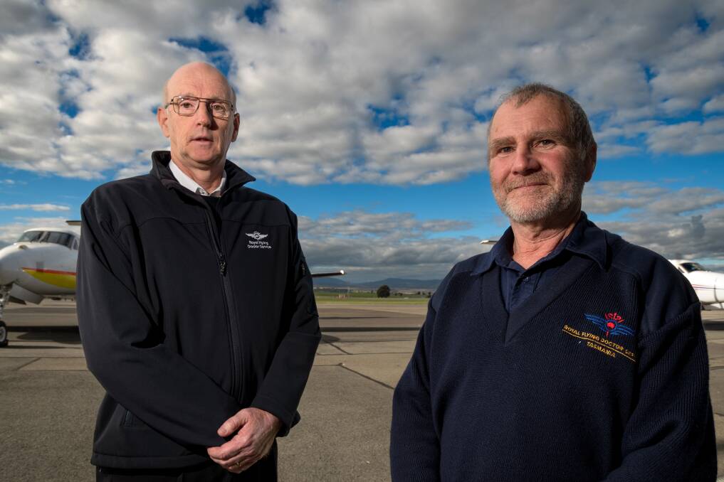Captain David Swiggs and senior base engineer Greg Foot have each served 25 years on the Royal Flying Doctor Service aero-medical operations in Tasmania. Picture: Phillips Biggs