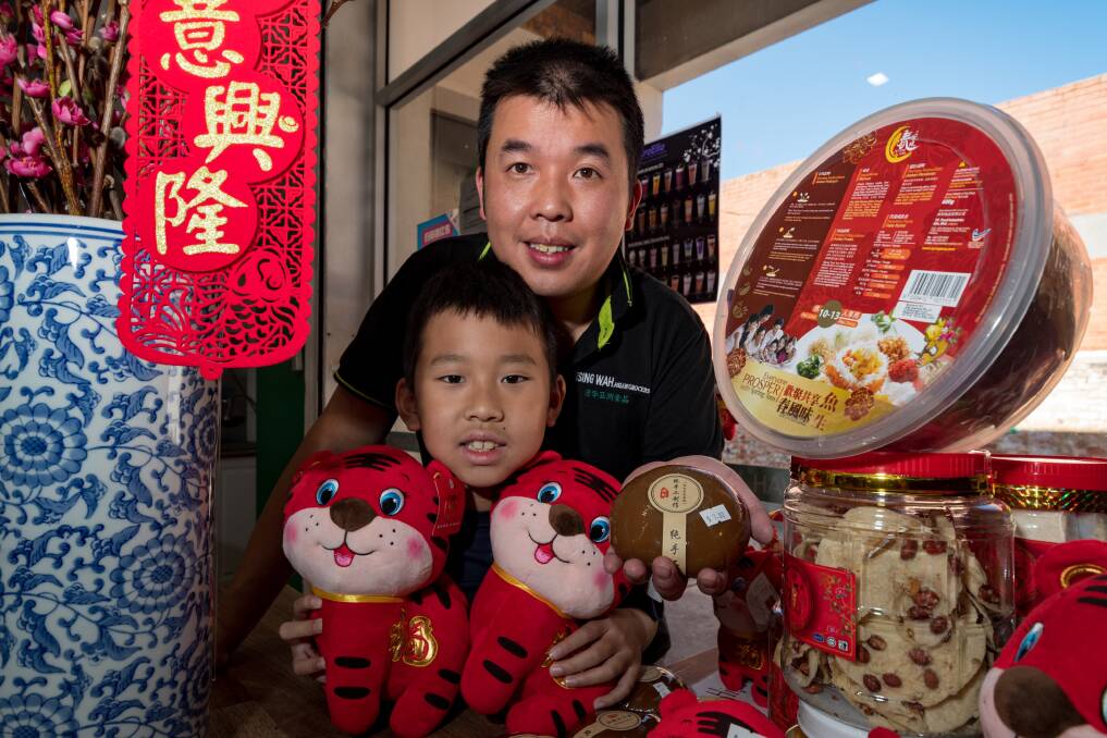 CELEBRATION: Bosco and and Anthony Kwong at Tsign Wah Asian Grocer prepare for the Chinese New Year. Picture: Phillip Biggs