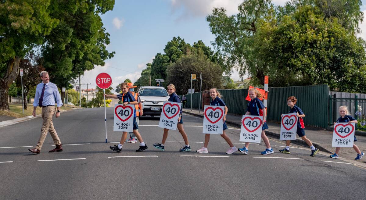 Transport minister Michael Ferguson crosses Abbott Street with St Thomas More's students Joshua Stacey, Eleanor Pietsch, Emily Stacey, Issy White, Marlon Rooney, Ella White. Picture: Phillip Biggs