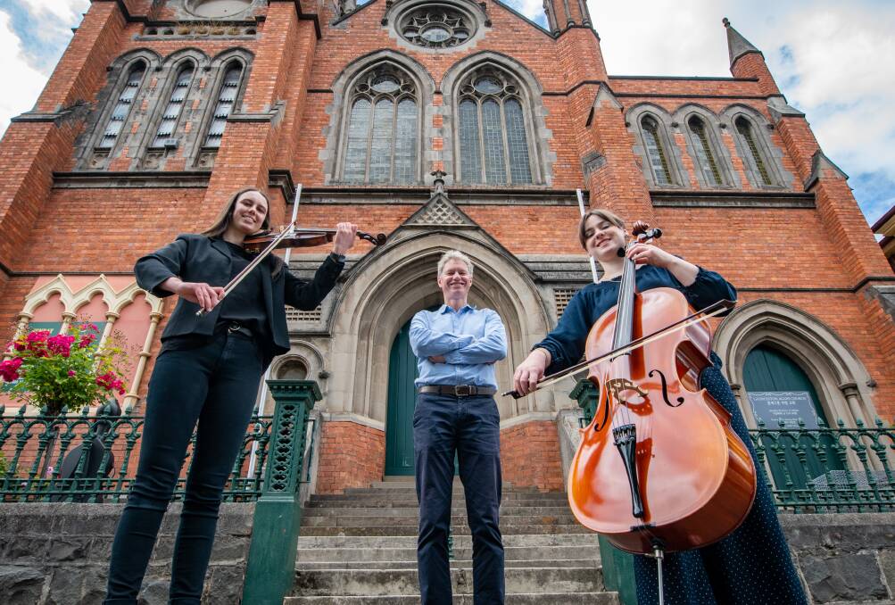 STRIKING A CHORD: Director of the St Cecilia Chamber Orchestra, Michael Stocks, with violinist Georgia Hillier and celloist Denni Sulzberger on the steps of the City Baptist Church in Frederick St. Picture: Paul Scambler