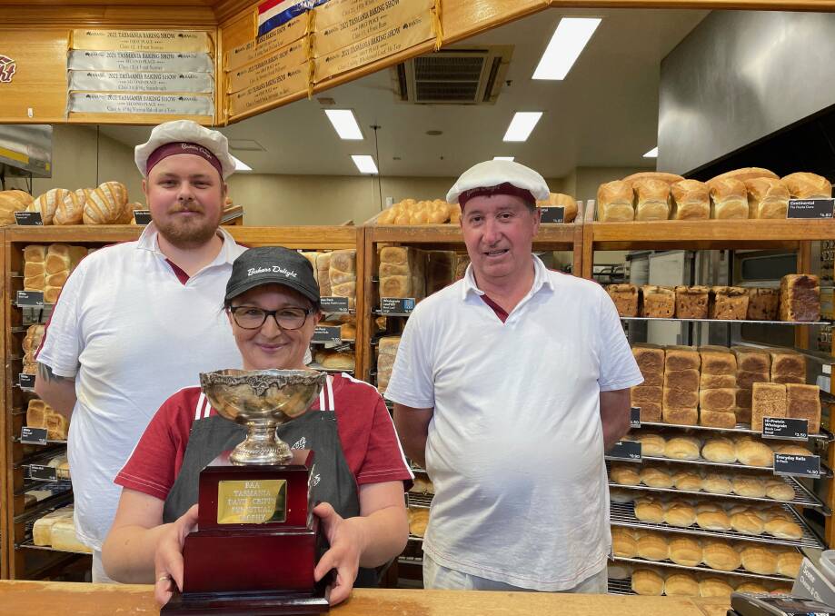 EARNING A CRUST: Michael Phillips, sales assistant Tammy Quinn and Darrell Whyte pose with this year's Champion Loaf of the Show Trophy. Picture: Joshua Peach