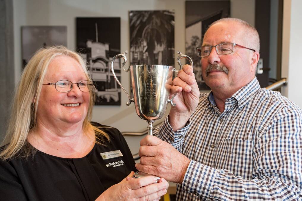 CUP RUNNETH OVER: Liz Woodworth and Ian McCallum with the recently rediscovered premiership cup. PIcture: Phillip Biggs