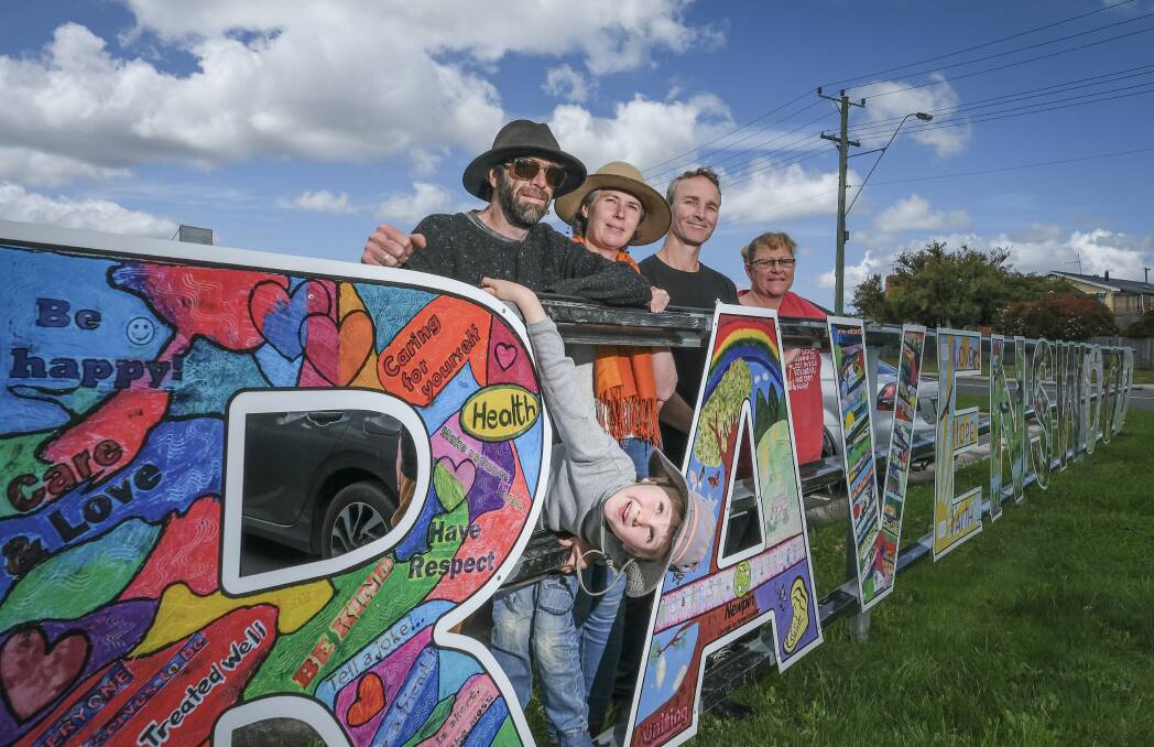 PAINTING THE TOWN: Daniel and Huon Kahl,5, Kathryn Kahl, Dean Cracknell and Ingred Dean at the Ravenswood shopping centre. Picture: Craig George