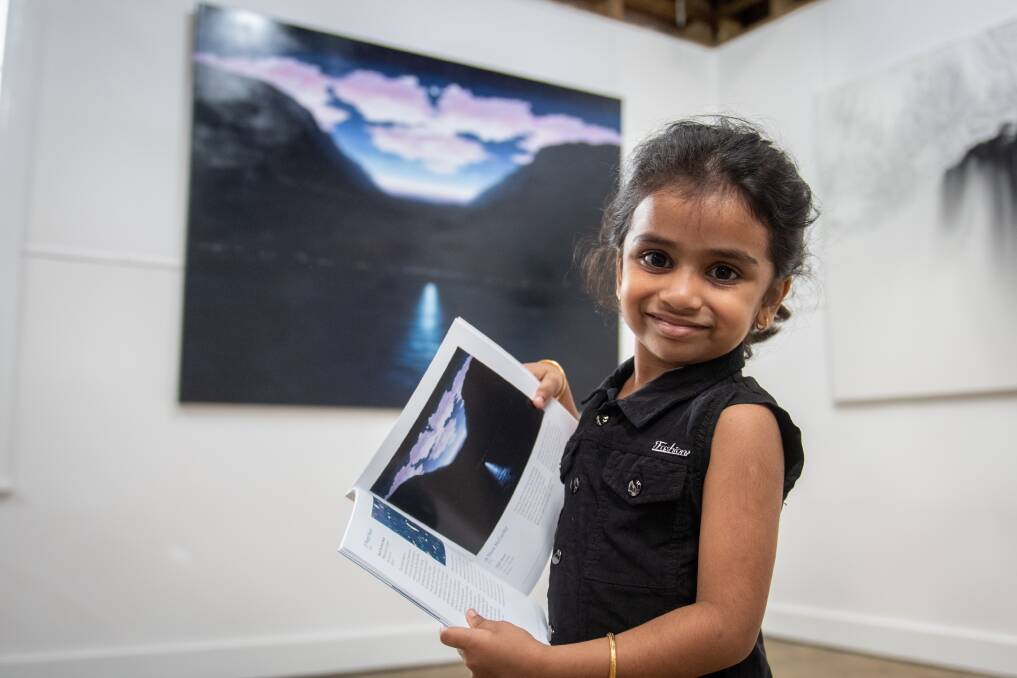 KIDS' PICK: Joann Arun, 3, of Evandale looks at the children's choice winning painting "High Moon" by Mark McCarthy of Victoria. Picture: Paul Scambler