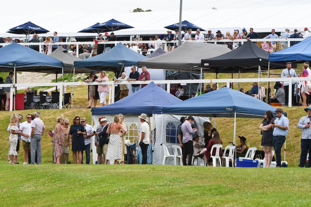 Cup uncertainty: Punters in the marquee area enjoying the sights and sounds of the Devonport Cup, despite low crowd numbers due to fears around COVID. Picture: Brodie Weeding.