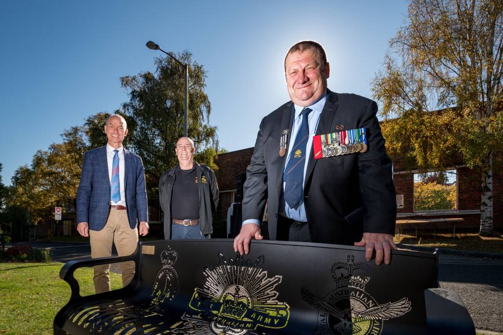 LEST WE FORGET: Guy Barnett, Garry Ivory and Peter Williams by a seat honouring the Australian Navy, Army and Airforce. Picture: Phillip Biggs