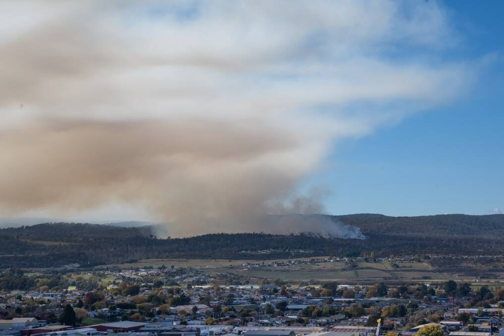 Looking East over Launceston to a large fuel reduction burn between Ravenswood and Rocherlea. Picture by Paul Scambler