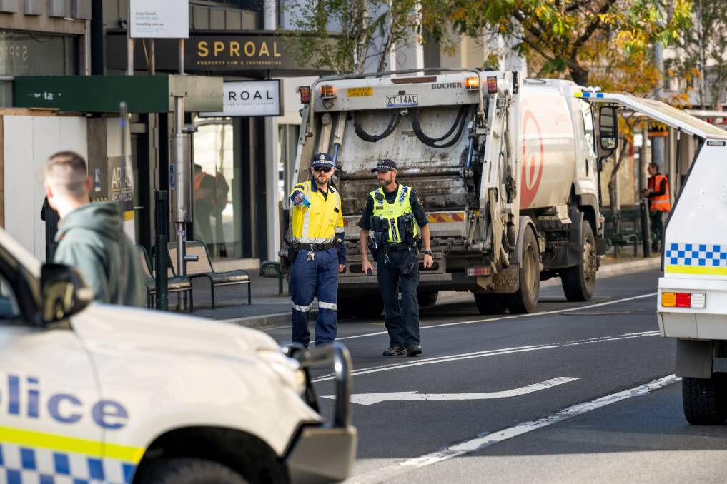 St John Street was closed for much of the day after a garbage truck hit an on-duty police officer while turning right from Paterson Street. Picture by Phillip Biggs