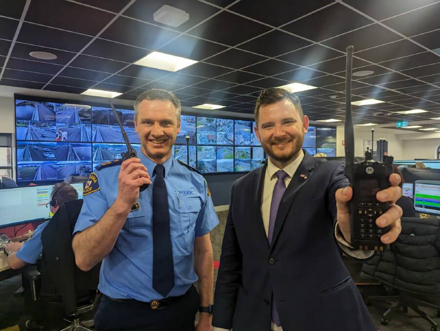 Acting Commissioner Jonathan Higgins and Police Minister Felix Ellis sign off on Tasmania Police's old radio network for the final time. Picture supplied