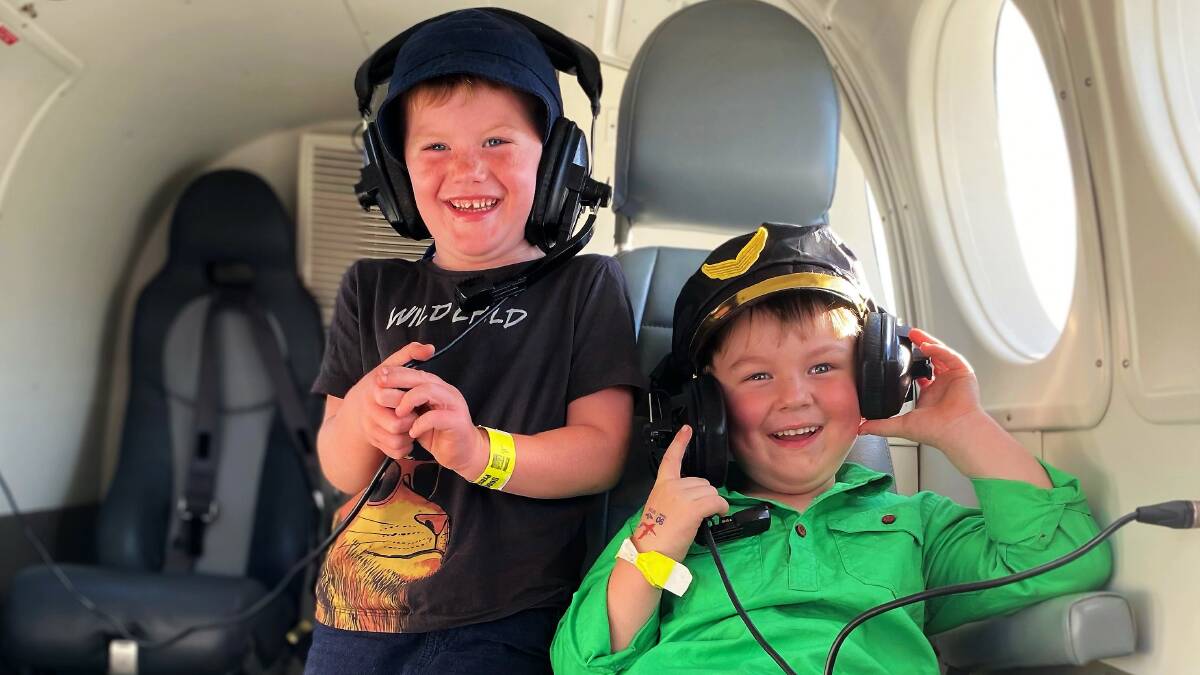 SUPPORT: Oscar Cripps (right) with his friend Jaxon in an aeromedical plane simulator at Preson Rodeo. Picture: Supplied 