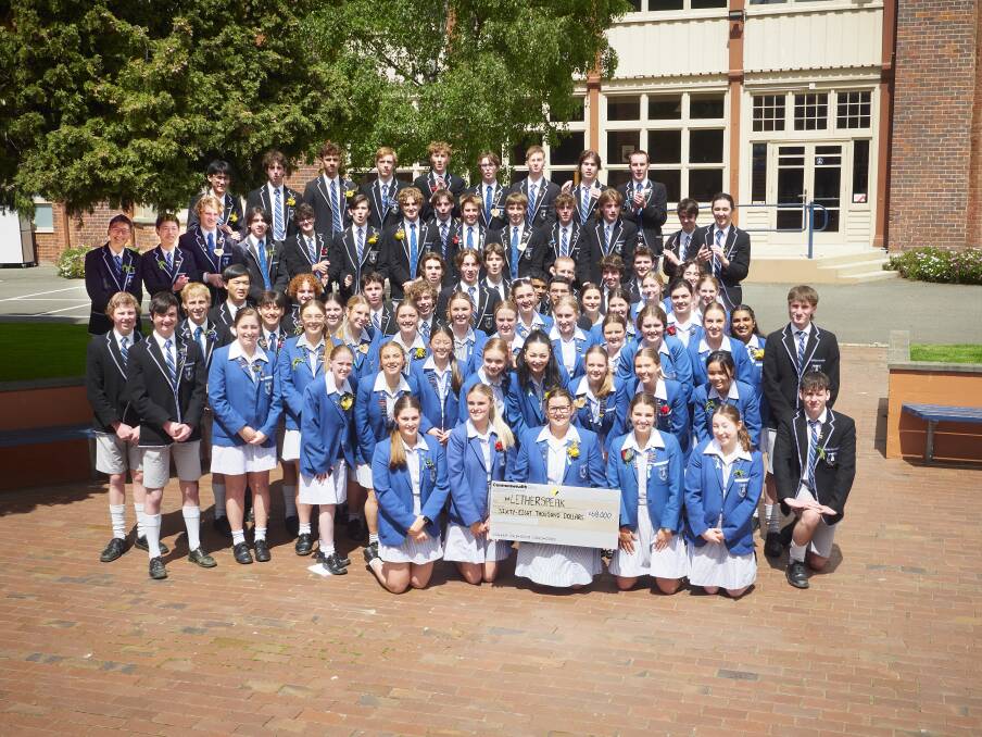 Year 12 Launceston Grammar students presenting the cheque for 68,000 after the 80km walkathon Picture by Rod Thompson
