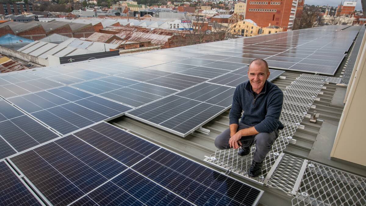 Craig Richman , owner of The Sebel on the roof with his 200 solar panels. Picture: Paul Scambler 