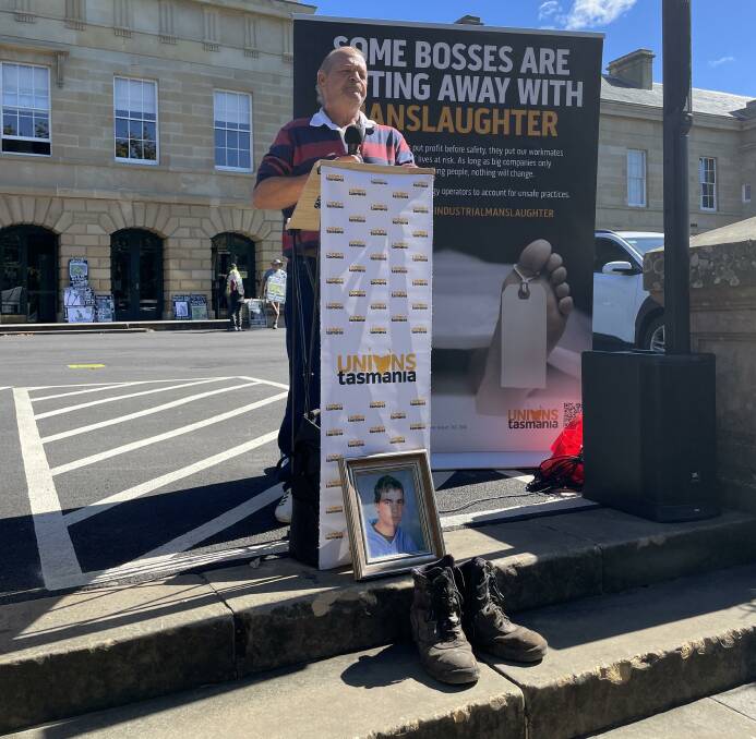 Guy Hudson speaking at the rally calling for industrial manslaughter laws in Tasmania. Below is the photo and work boots of his son, Matthew. Picture by Ben Seeder 
