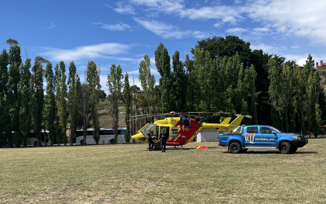 A mechanic was working on the helicopter, which had landed in the Esplanade park on the banks of the Derwent River in New Norfolk. Picture by Ben Seeder