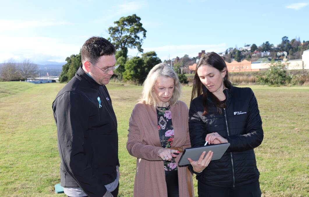 Launceston acting mayor Matthew Garwood, Tasmanian Labor senator Helen Polley and City of Launceston water team leader Erica Deegan look over plans to ensure Launceston is better protected and prepared against flooding. Picture supplied
