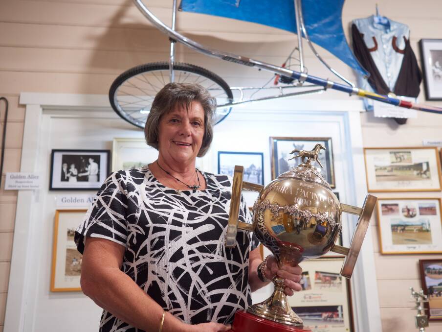 Carrick Harness Racing museum coordinator Karen Dornauf holds a trophy at the museum opening. Picture Rod Thompson