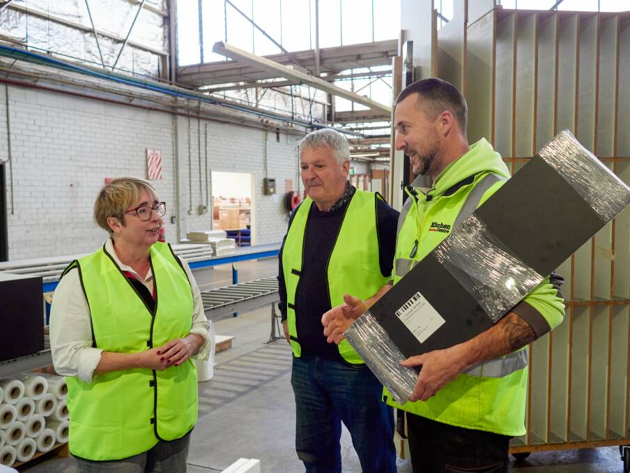 Labor member for Bass Michelle O'Byrne and Leigh Rodman tour his existing factory space and chat with employee Matthew Kean. Picture Rod Thompson