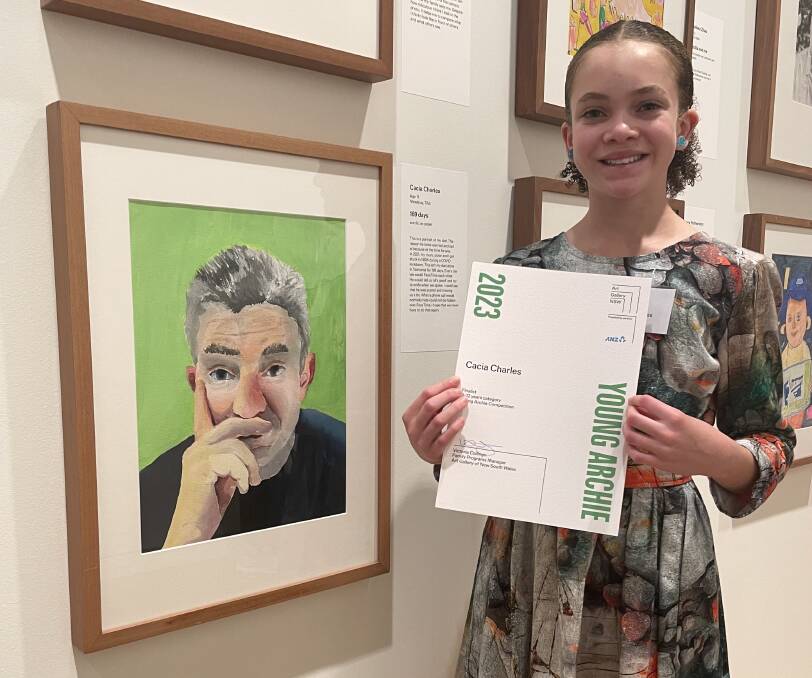 Cacia Charles (11) with her portrait of her dad, Ben Charles, at the Young Archie competiton in Sydney. Picture supplied
