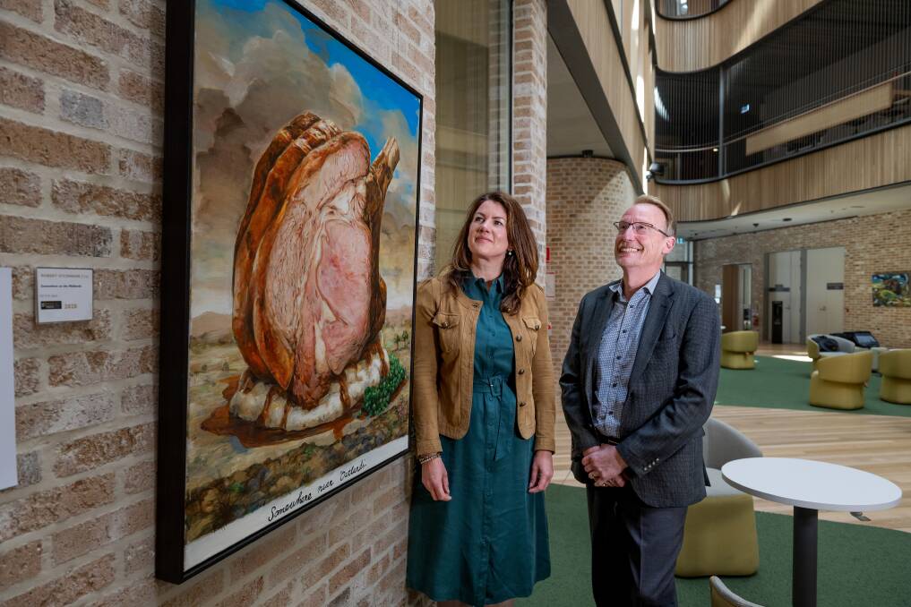 Glover Prize curator Megan Dick and UTAS academic director of academy gallery and exhibitions Malcom Bywaters with Robert O'Connor's work, Somewhere on the midlands. Picture Phillip Biggs