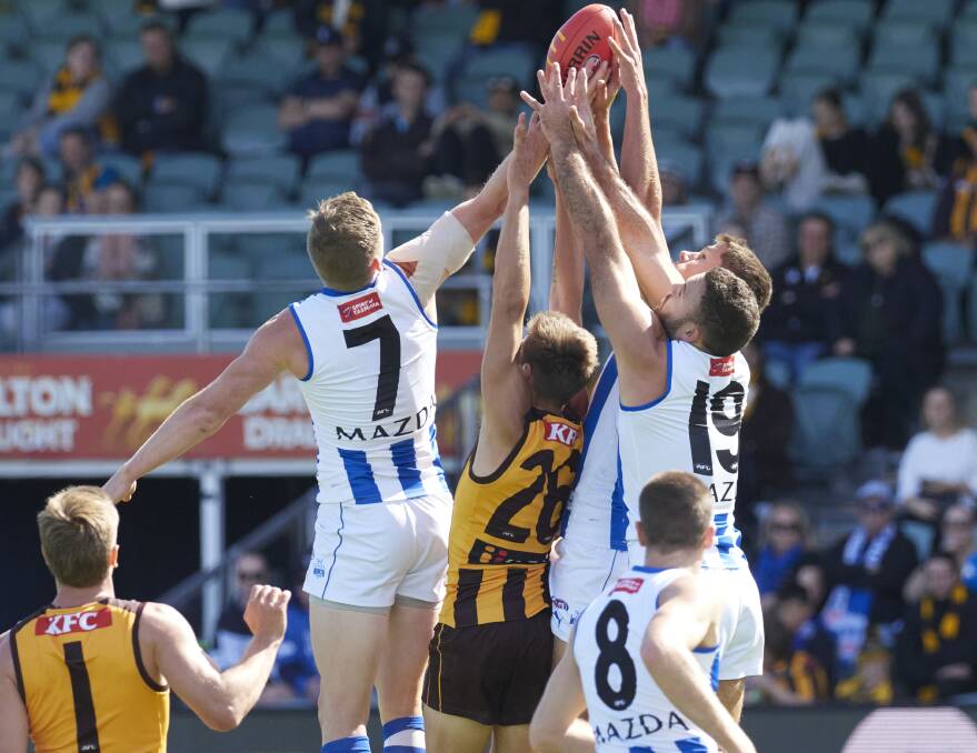 Hawthorn's Fergus Greene and North Melbourne's Jack Ziebell, Griffin Logue and Daniel Howe in a marking contest.
