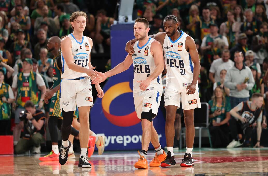 Melbourne United's Luke Travers and Ian Clark praise Matthew Dellavedova for his game-winning shot. Picture by Kelly Defina/Getty Images