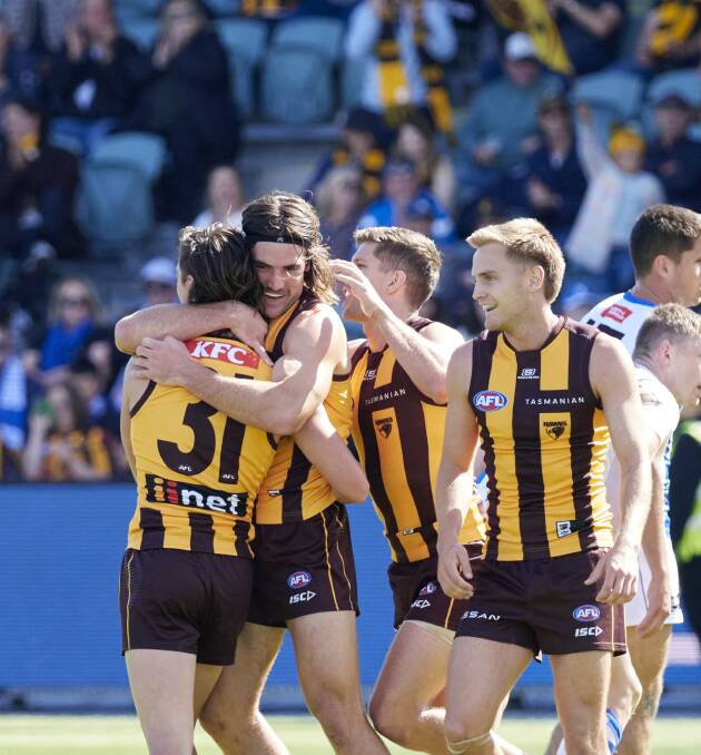Hawks players congratulate goal-kicker Connor McDonald. Pictures by Rod Thompson