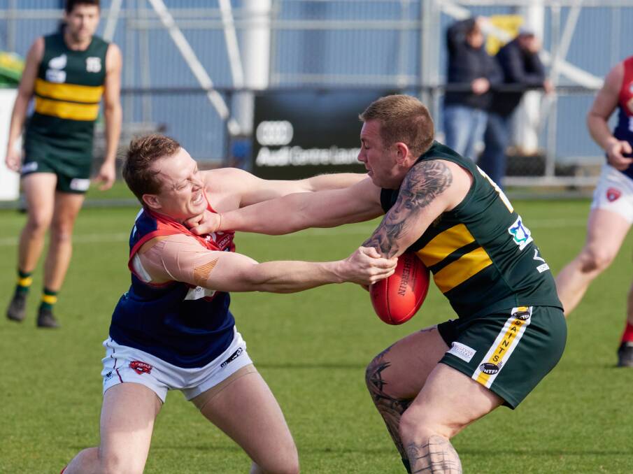 St Pats' Jordan Tepper attempts to fend off Lilydale's Mark Walsh. Pictures by Rod Thompson