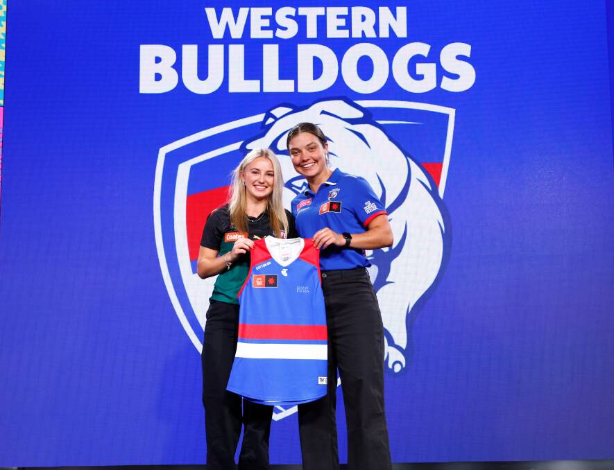 Glenorchy's Brooke Barwick was presented her jumper by Western Bulldogs' Ellie Blackburn after being selected by the club at pick four of the AFLW draft. Picture by Dylan Burns/AFL Photos via Getty Images