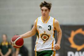 St Patrick's Noah Hedger carries the ball down the court at the North Regional High School basketball championships at Elphin Sports Centre. Pictures by Phillip Biggs