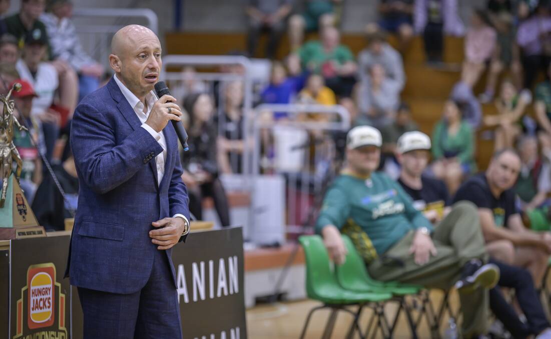 Larry Kestelman speaks at Elphin Sports Centre on Saturday as JackJumpers coach Scott Roth and captain Clint Steindl look on. Picture by Craig George