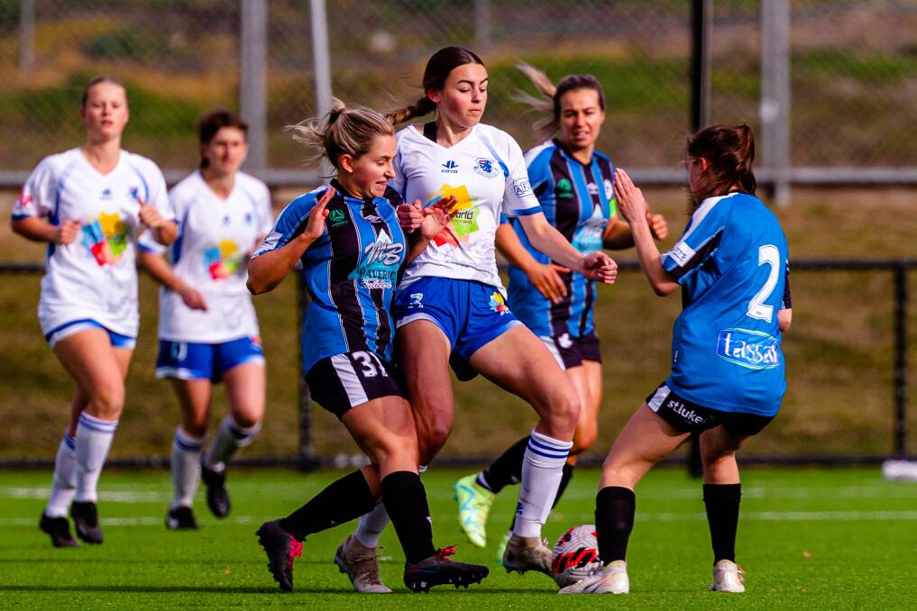Kingborough's Phoebe Clifford tackles Lucy Smith, of Launceston United, in last week's statewide cup tie. Picture by Anthony Corke, Solstice Digital