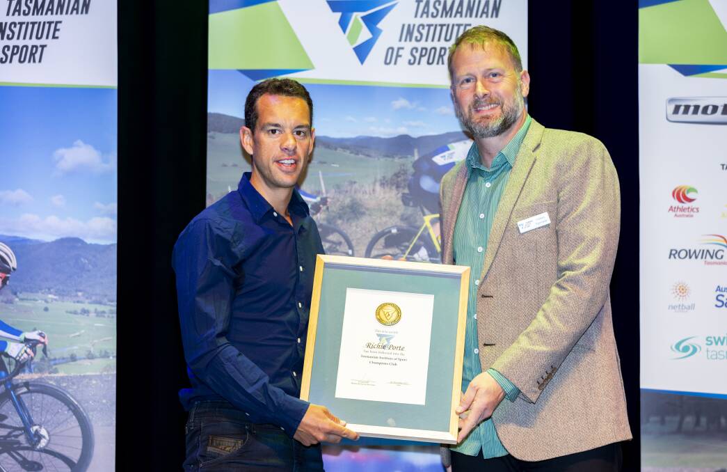 Richie Porte welcomed into the Champions Club by TIS director Adam Sproule.