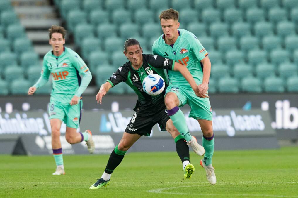 Western United's Lachlan Wales and Perth Glory's Callum Timmins compete during their A-League match at UTAS Stadium in 2022 Picture by Phillip Biggs