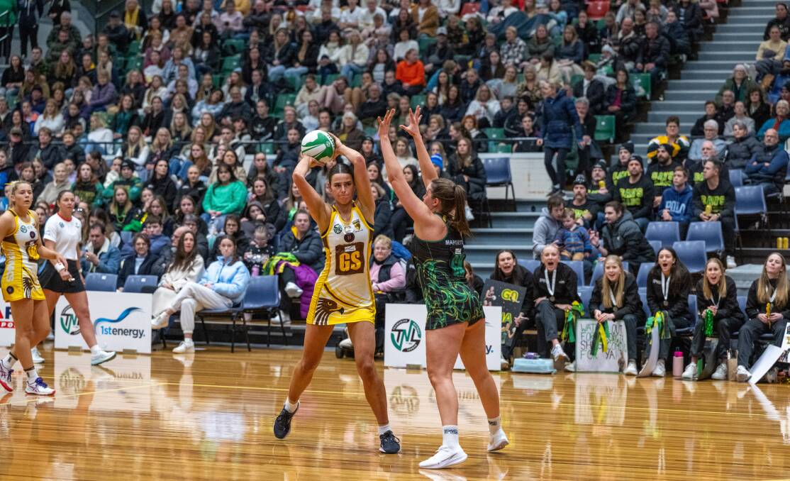 Northern Hawks' Ash Mawer and Cavaliers' Estelle Margetts in action during the Tasmanian Netball League grand final at the Silverdome in July. Picture by Paul Scambler 