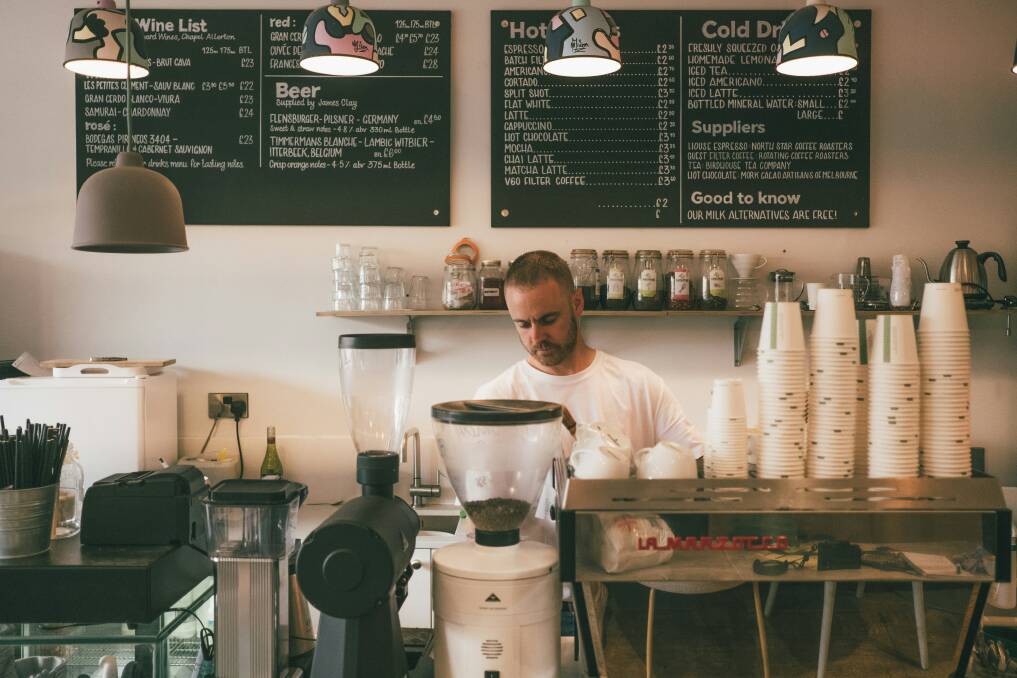 A barista making coffee in a cafe. Picture from Unsplash. 